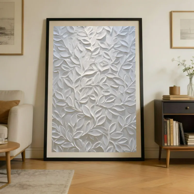 Close-up of a white relief-style artwork showing overlapping leafy branches with layered texture on a cream background.