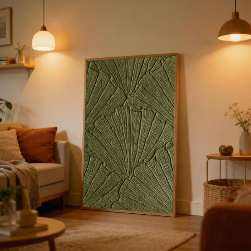 Close-up of a botanical texture art print featuring overlapping ginkgo leaves in raised relief, all in deep olive green.